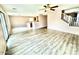 Bright living room features wood-look flooring and a ceiling fan at 23200 W Ashleigh Marie Dr, Buckeye, AZ 85326