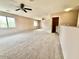 Expansive loft with carpet, ceiling fans, and multiple windows at 23200 W Ashleigh Marie Dr, Buckeye, AZ 85326
