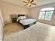Spacious main bedroom featuring a ceiling fan and natural light from the large window at 23200 W Ashleigh Marie Dr, Buckeye, AZ 85326