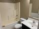 Clean bathroom with a shower-tub combo, vanity, and tile accents throughout at 29101 N Yellow Bee Dr, San Tan Valley, AZ 85143