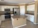 Well-equipped kitchen with ample counter space, a central island, and sleek stainless steel appliances at 29101 N Yellow Bee Dr, San Tan Valley, AZ 85143