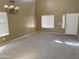Spacious living room with new carpet, a chandelier, and plenty of natural light from windows at 29101 N Yellow Bee Dr, San Tan Valley, AZ 85143