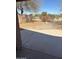 Covered patio with a peek at the desert views, framed by mature trees at 29101 N Yellow Bee Dr, San Tan Valley, AZ 85143
