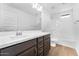 Bathroom with a large mirror, dark wood cabinets, and tiled floors at 10864 E Texas Ave, Mesa, AZ 85212