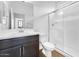 Bright bathroom with white vanity, glass shower, and neutral ceramic tile at 10864 E Texas Ave, Mesa, AZ 85212