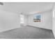 View of bedroom with neutral carpet, white walls, and large window showing neighborhood at 10864 E Texas Ave, Mesa, AZ 85212
