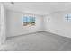 Bright bedroom featuring neutral carpet, white walls, and a window framing neighborhood views at 10864 E Texas Ave, Mesa, AZ 85212