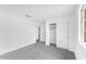 Bedroom with neutral carpet, white walls, closet and a door leading to another room at 10864 E Texas Ave, Mesa, AZ 85212