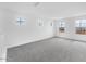 Spacious bonus room with natural light, neutral carpet and white walls at 10864 E Texas Ave, Mesa, AZ 85212