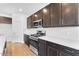 Kitchen featuring stainless steel appliances, white subway tile backsplash, and dark cabinets at 10864 E Texas Ave, Mesa, AZ 85212