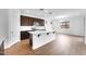 Bright kitchen featuring an island, modern appliances, and hardwood floors at 10864 E Texas Ave, Mesa, AZ 85212