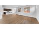 Large living room showcasing hardwood floors, a modern kitchen, and multiple windows at 10864 E Texas Ave, Mesa, AZ 85212