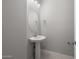 Bathroom featuring a pedestal sink, an oval mirror, and tile floors at 7691 W Cactus Wren Way, Florence, AZ 85132