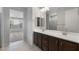A spacious bathroom offers a double vanity, large mirror, and view to the bedroom and walk-in shower at 7691 W Cactus Wren Way, Florence, AZ 85132