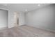 An empty bedroom with neutral carpeting, white walls, and a bathroom door awaits customization to become a personalized sanctuary at 7691 W Cactus Wren Way, Florence, AZ 85132