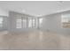 Spacious living room with tile flooring, neutral paint, and sunlit windows at 7691 W Cactus Wren Way, Florence, AZ 85132