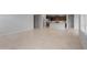 Open-concept space showing the living room with tile floor next to kitchen at 7691 W Cactus Wren Way, Florence, AZ 85132