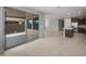 Open-concept living space with tile flooring and lots of natural light from the sliding glass door leading to the outdoor patio at 7691 W Cactus Wren Way, Florence, AZ 85132