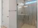 A modern shower featuring stylish tiling, a glass door, and a rainfall showerhead offers a spa-like experience at 7691 W Cactus Wren Way, Florence, AZ 85132