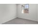 Bedroom with neutral carpet, paint and large window at 12333 W Marguerite Ave, Avondale, AZ 85323