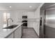 Well-equipped kitchen featuring stainless steel appliances, white cabinets, and elegant quartz countertops at 12333 W Marguerite Ave, Avondale, AZ 85323