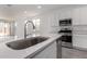 Bright kitchen with a sink overlooking the quartz countertop and stainless steel appliances at 12333 W Marguerite Ave, Avondale, AZ 85323