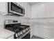 Close-up shot of modern kitchen featuring stainless steel appliances and white cabinets at 12333 W Marguerite Ave, Avondale, AZ 85323