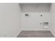Bright laundry room with gray tiled floor and white walls showing various utility hookups at 12333 W Marguerite Ave, Avondale, AZ 85323