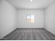 Cozy bedroom featuring neutral carpet, a bright window, and ample natural light for a tranquil space at 24629 W St Catherine Ave, Buckeye, AZ 85326
