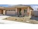 Charming home featuring a tile roof, low maintenance desert landscaping, and an attached two car garage at 24629 W St Catherine Ave, Buckeye, AZ 85326
