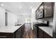 Well-equipped kitchen with stainless steel appliances, granite countertops, wood floors, and an open concept design at 24629 W St Catherine Ave, Buckeye, AZ 85326