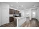 Bright, open kitchen featuring stainless steel appliances, wood flooring, a center island, and granite countertops at 24629 W St Catherine Ave, Buckeye, AZ 85326