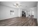 Spacious living area with wood flooring, bright natural light, and an open floor plan for easy entertaining at 24629 W St Catherine Ave, Buckeye, AZ 85326