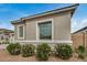 Front exterior view of a modern home, accented with desert landscaping and flower bushes at 2567 N 195Th Dr, Buckeye, AZ 85396