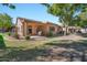 Backyard patio with seating area and landscaping at 9612 E Champagne Dr, Sun Lakes, AZ 85248