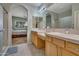 Main bathroom with double vanity and bedroom view at 9612 E Champagne Dr, Sun Lakes, AZ 85248