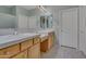 Double sink bathroom with light wood cabinets at 9612 E Champagne Dr, Sun Lakes, AZ 85248