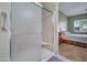 Bathroom with shower, double vanity, and view of bedroom at 9612 E Champagne Dr, Sun Lakes, AZ 85248