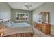 Bedroom with ceiling fan, dresser, and window with shutters at 9612 E Champagne Dr, Sun Lakes, AZ 85248