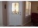 Entryway with a white door and glass inserts, a burgundy chair at 9612 E Champagne Dr, Sun Lakes, AZ 85248