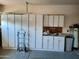 Garage with ample storage cabinets and shelving at 9612 E Champagne Dr, Sun Lakes, AZ 85248