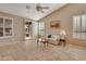 Gathering room with tiled floors, sofa, and access to backyard at 9612 E Champagne Dr, Sun Lakes, AZ 85248