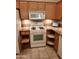 White appliances and light wood cabinets in this kitchen at 9612 E Champagne Dr, Sun Lakes, AZ 85248