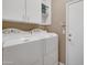Laundry room with washer, dryer, and cabinets at 9612 E Champagne Dr, Sun Lakes, AZ 85248