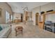 Spacious living room with tile floors and views to kitchen and dining areas at 9612 E Champagne Dr, Sun Lakes, AZ 85248