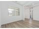 Bright living room featuring hardwood floors and large windows offering lots of natural light at 11946 W Parkway Ln, Avondale, AZ 85323