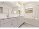 Bright bathroom with double sinks, soaking tub, and walk-in shower at 11949 W Parkway Ln, Avondale, AZ 85323