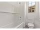 Well-lit bathroom showcasing a shower-tub combo with tiled walls and a window at 11949 W Parkway Ln, Avondale, AZ 85323