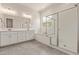 Bright bathroom with double sinks, soaking tub, and walk-in shower at 11949 W Parkway Ln, Avondale, AZ 85323