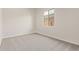 Inviting bedroom with soft carpet, neutral paint, and a large bright window at 11949 W Parkway Ln, Avondale, AZ 85323